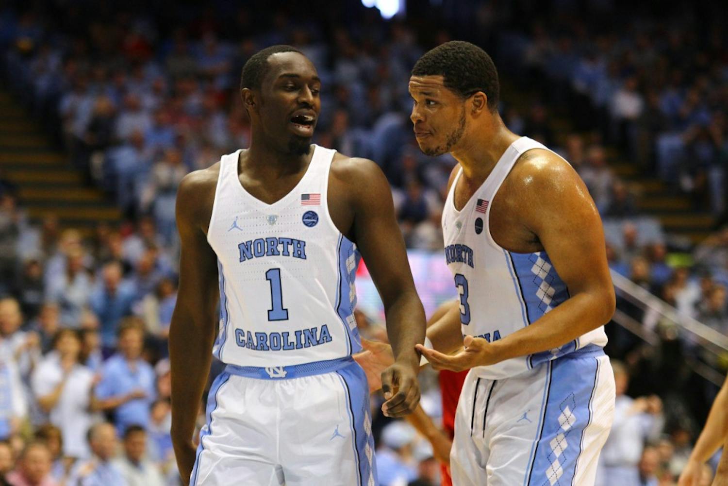 Junior forward Theo Pinson (1) strategizes with senior forward Kennedy Meeks (3) during the game against N.C. State.