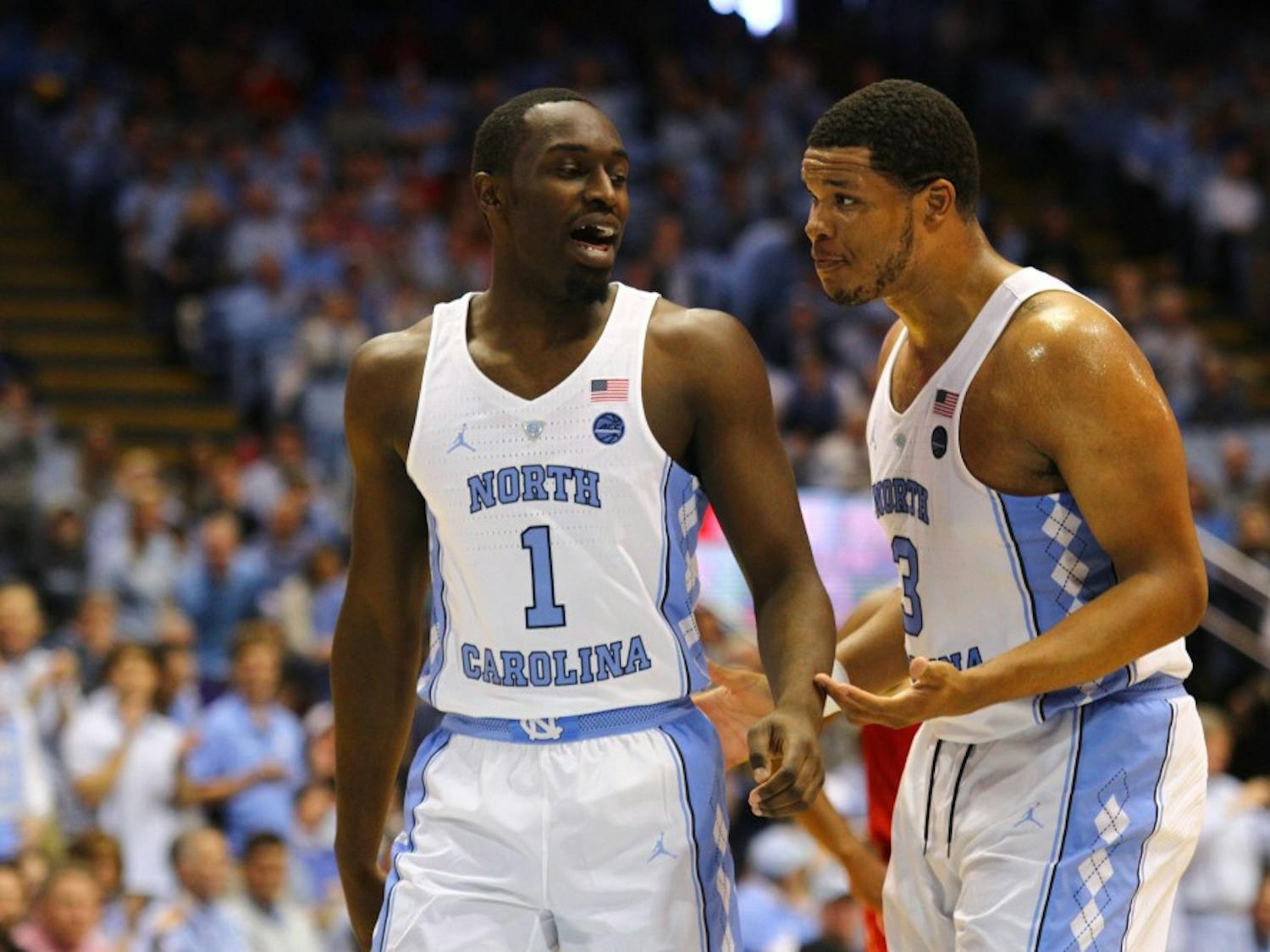 Junior forward Theo Pinson (1) strategizes with senior forward Kennedy Meeks (3) during the game against N.C. State.