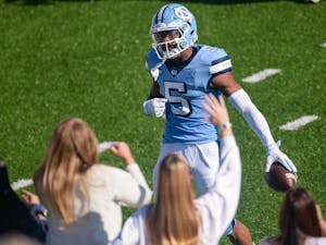 UNC senior wide receiver Dazz Newsome (5) celebrates a touchdown in front of the student section of Kenan Memorial Stadium during a game against Wake Forest on Saturday, Nov. 14, 2020. UNC beat Wake Forest 59-53.