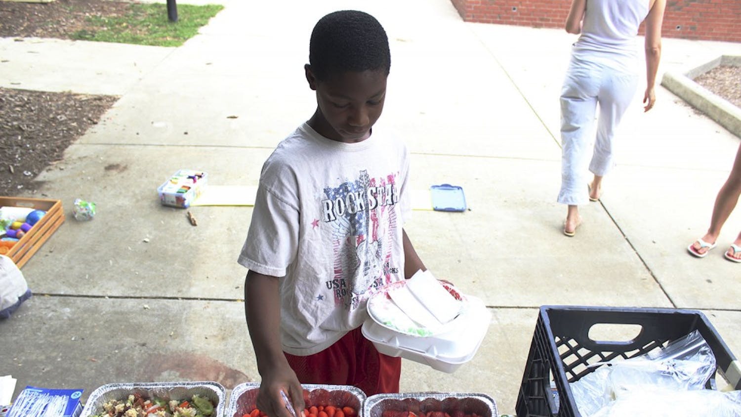 Anton Enoch serves himself food during Friday Fun Day, a free lunch event for families in the Chapel Hill area. 