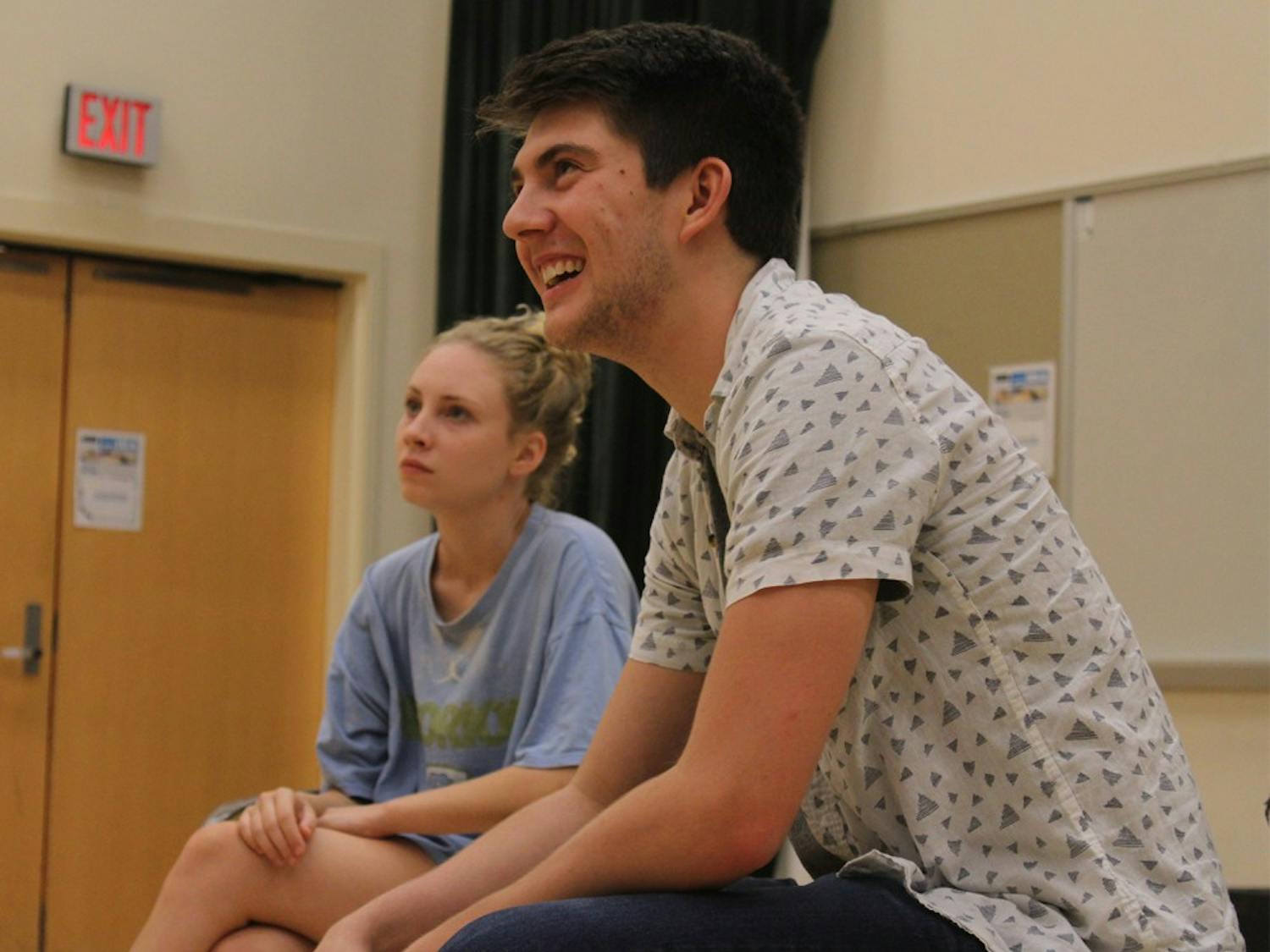 A day in the life of a CHIP: Senior Luke Miller (Business Administration and Economics Major and minor in cognitive science) looks on as his fellow CHIP members practice a skit. Bobby Decker (far left) (junior, English/Political Science Major) and Isabelle DeWitt (center) (senior, dramatic arts major) also look on.
