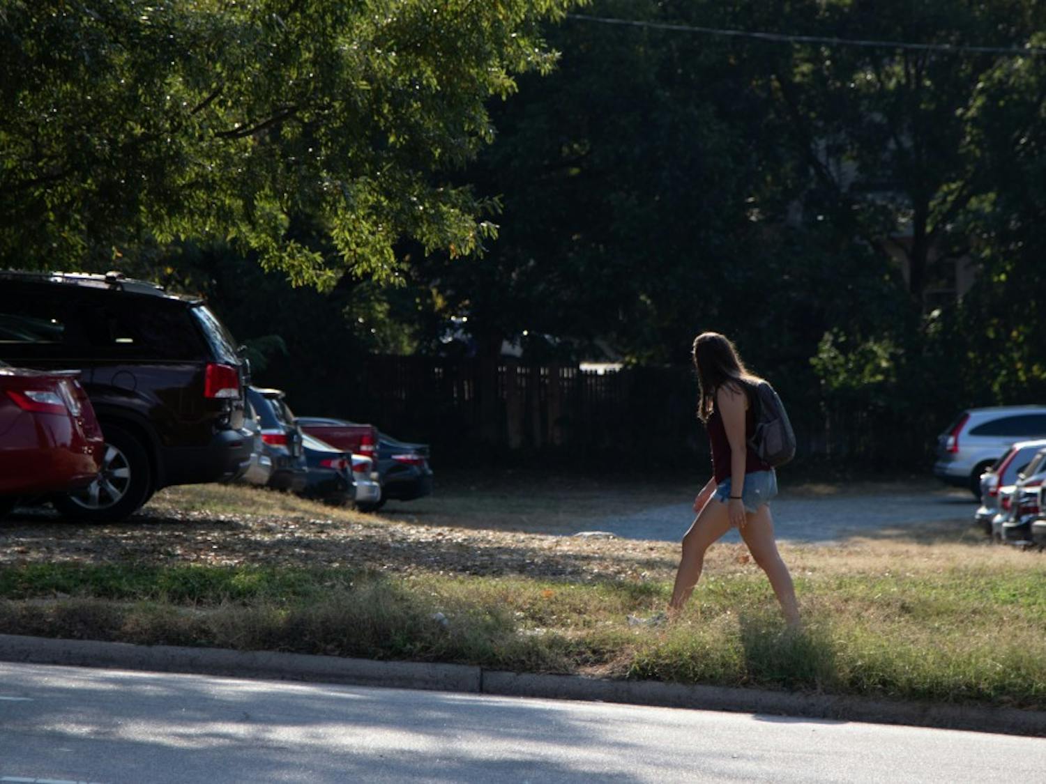 On Sunday, Sept. 29th 2019, a student walks by the vacant lot on Rosemary Street where a new hotel is planned to be built.&nbsp;