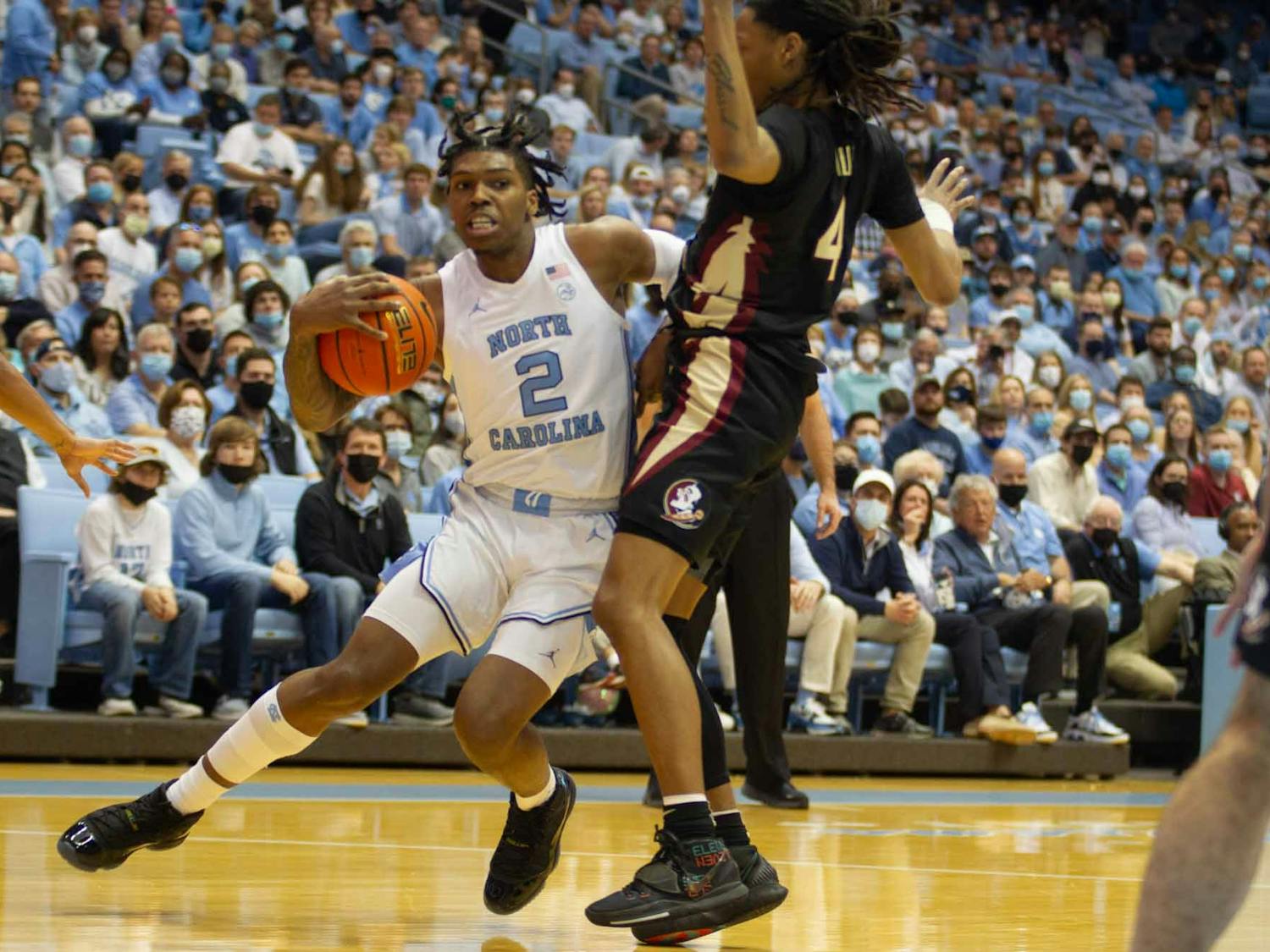 Sophomore guard Caleb Love (2) tries to drive past his defender for a layup during the matchup against Florida State on Feb. 12, 2022 at the Dean E. Smith Center in Chapel Hill. Love ended with 18 points.