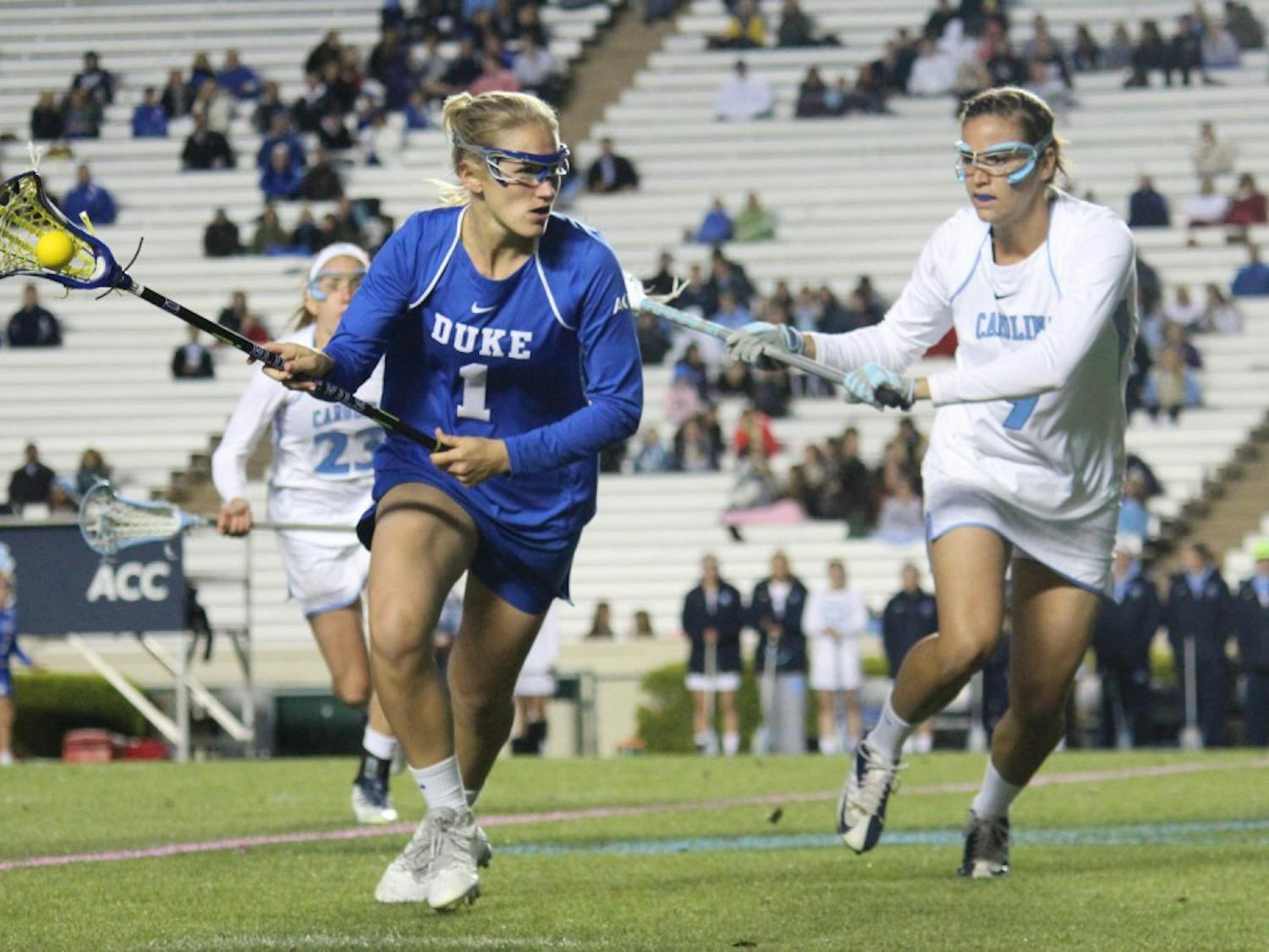 Women's lacrosse suffers a loss 7-6 to Duke in overtime on Wednesday in Kenan Stadium. Defender Margaret Corzel (9) attempts to block out an opponent. 