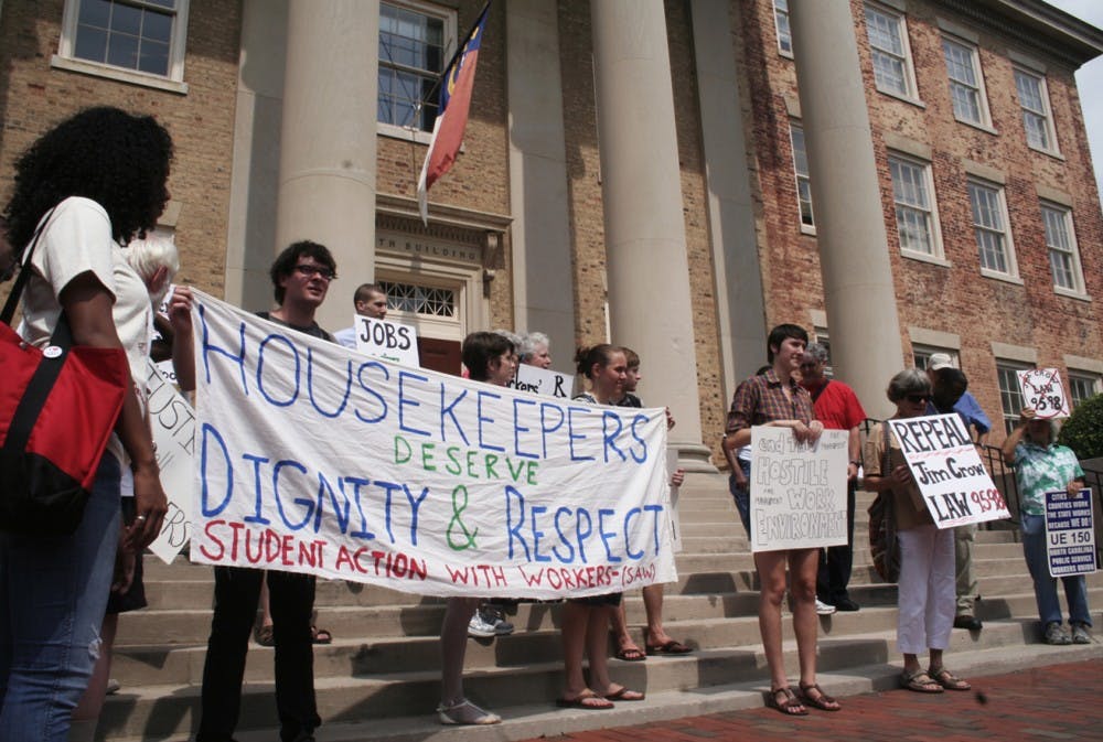 Students, housekeepers, and community members march on South Building to protest the University’s Wage-Hour policy Wednesday afternoon. They presented Chancellor Holden Thorp’s office with a copy of their grievances concerning the matter after staging a small rally. 