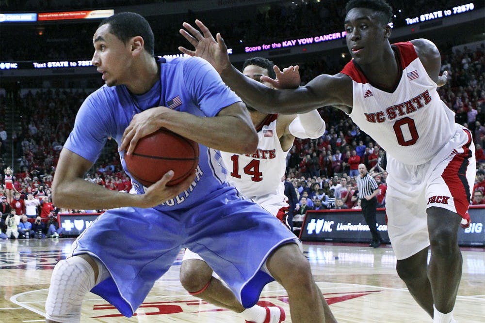 Junior point guard Marcus Paige holds onto a pass off an inbounds play against N.C. State’s Abdul-Malik Abu during No. 15 UNC’s 81-79 victory over the Wolfpack on Wednesday night at PNC Arena in Raleigh. 