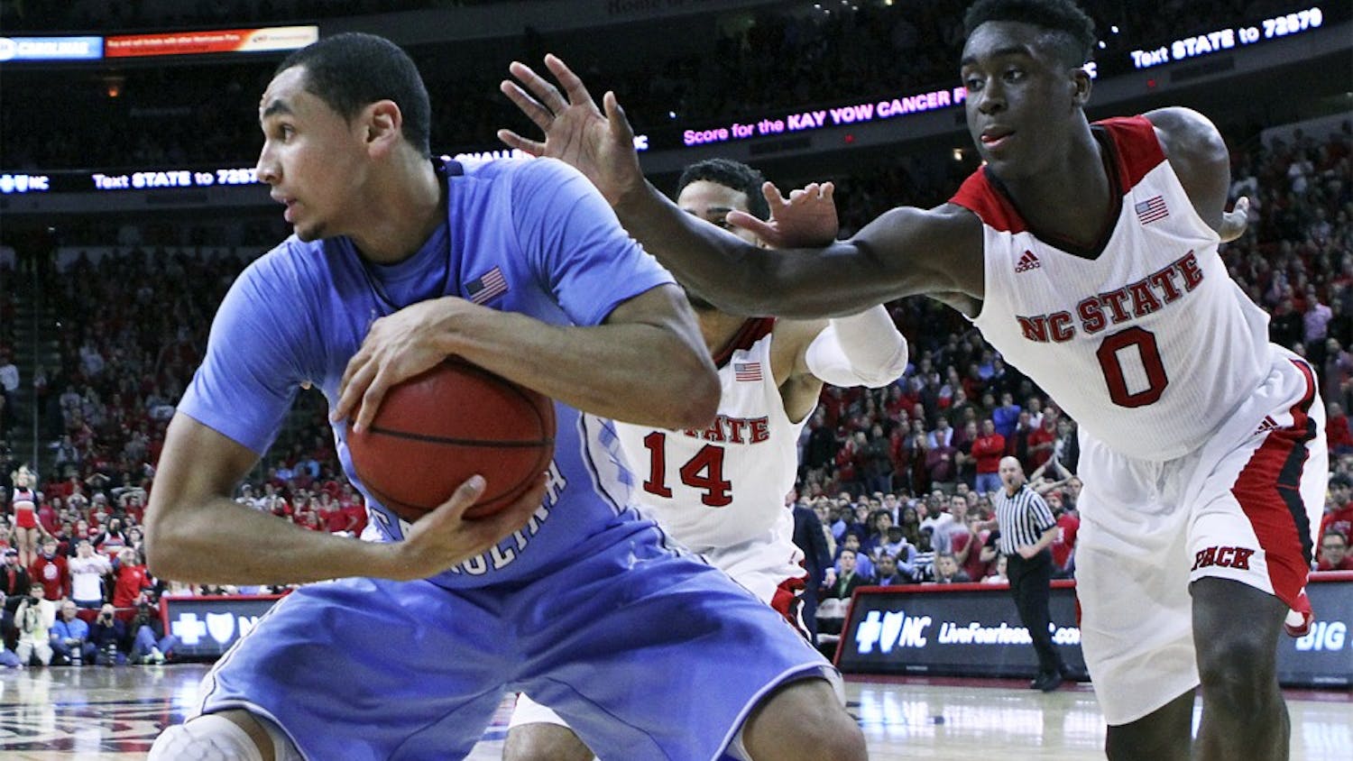 Junior point guard Marcus Paige holds onto a pass off an inbounds play against N.C. State’s Abdul-Malik Abu during No. 15 UNC’s 81-79 victory over the Wolfpack on Wednesday night at PNC Arena in Raleigh. 