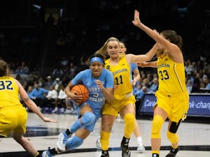 UNC junior guard Kennedy Todd-Williams (3) prepares for a layup against Michigan guard Greta Kampschroeder (11) at the Spectrum Center in Charlotte, N.C., on Tuesday, Dec. 20, 2022. UNC fell to Michigan 76-68.