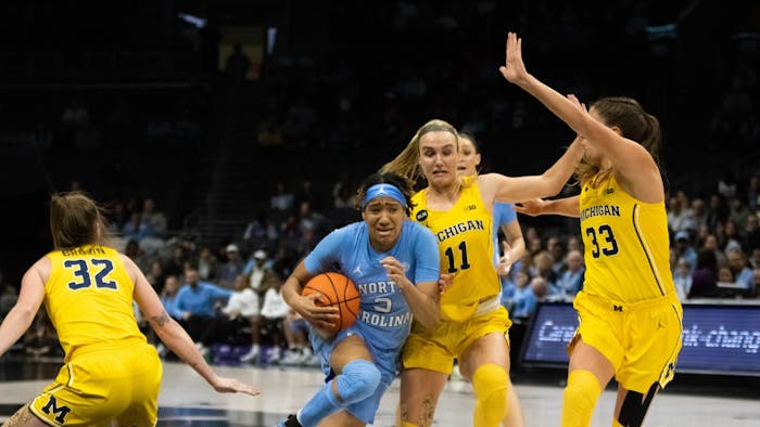 UNC junior guard Kennedy Todd-Williams (3) prepares for a layup against Michigan guard Greta Kampschroeder (11) at the Spectrum Center in Charlotte, N.C., on Tuesday, Dec. 20, 2022. UNC fell to Michigan 76-68.