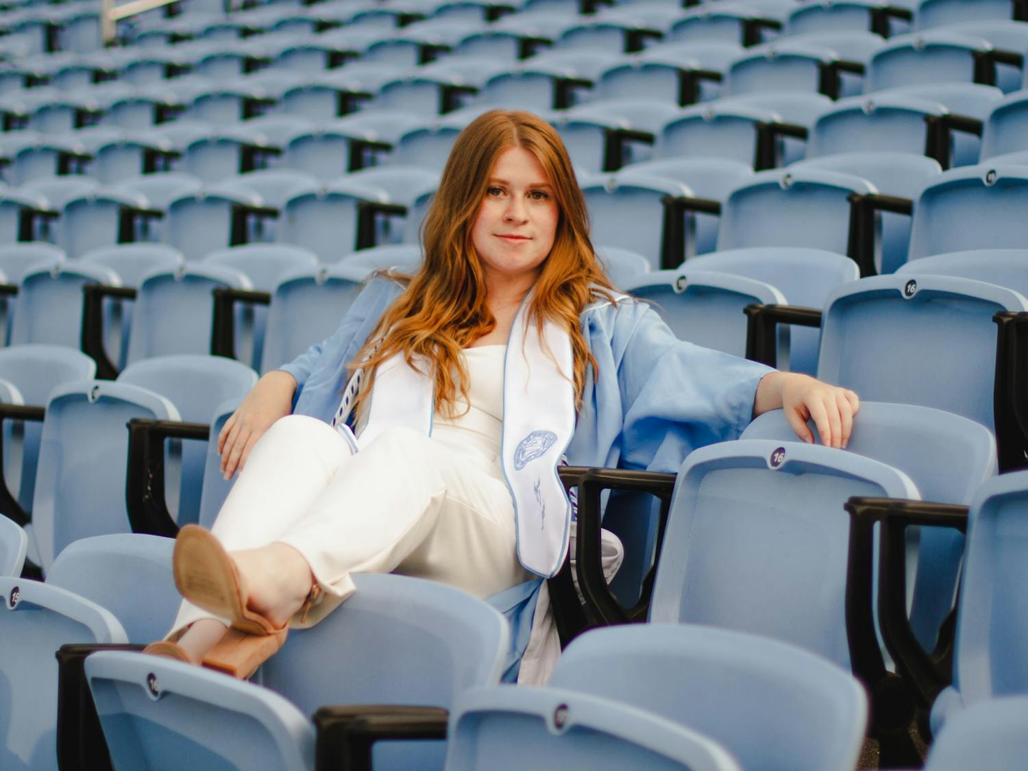 Sophie Swift, a senior computer science major, poses for a portrait at Kenan Memorial Stadium on Wednesday, Apr. 28, 2021. "I want to be true to myself," says Swift, who's opting to wear a jumpsuit to the ceremony. "And dress in a way that really feels like me."