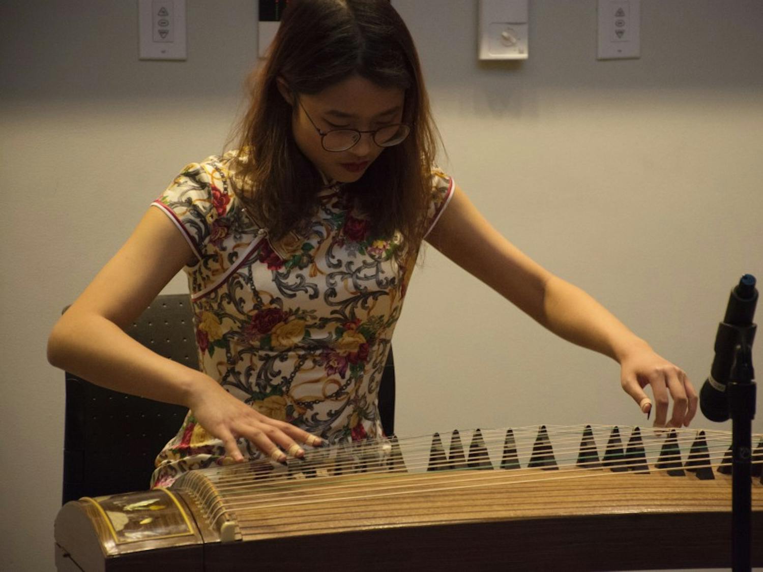 A woman performs zither music at Friday's 2018 Lunar Year Celebration. Photo courtesy of the Friendship Association of Chinese Students and Scholars.