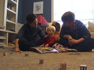 Jennifer Tharrington (left) and spouse Anna play with their son Jack, 18 months, in his play room in their home in Chapel Hill on Sunday, Feb. 15.