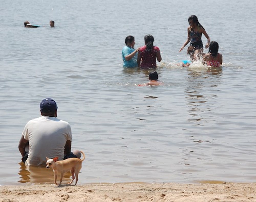 	Visitors cool off Tuesday afternoon on the shores of Falls Lake. DTH/Jamie Emmerman