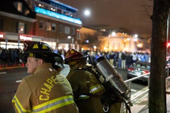 Chapel Hill firefighters monitor the rush to Franklin Street follwing  the Tar Heel's 88-72 win against the Duke Blue Devils on Wednesday, Feb. 20, 2019 in Chapel Hill, N.C. It is a yearly tradition for UNC students to run to the intersection of the Franklin Street and Columbia Street after a Tar Heel win against the Blue Devils.