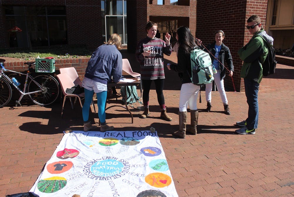 Members of UNC Real Food Challenge talked to students about what Real Food is and the group's goals for the semester in Davis Courtyard on Wednesday.