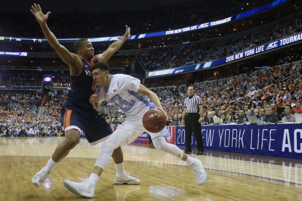 North Carolina wing Justin Jackson (44) drives on Virginia's Devon Hall (0) in the 2016 ACC Tournament final. UNC won that game, 61-57, and faces the Cavaliers on Saturday for the first time this season.