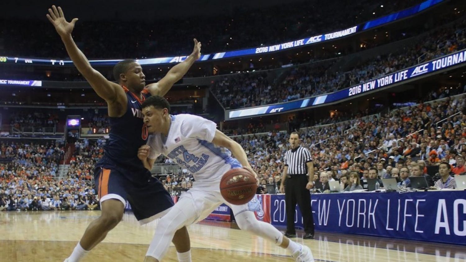 North Carolina wing Justin Jackson (44) drives on Virginia's Devon Hall (0) in the 2016 ACC Tournament final. UNC won that game, 61-57, and faces the Cavaliers on Saturday for the first time this season.