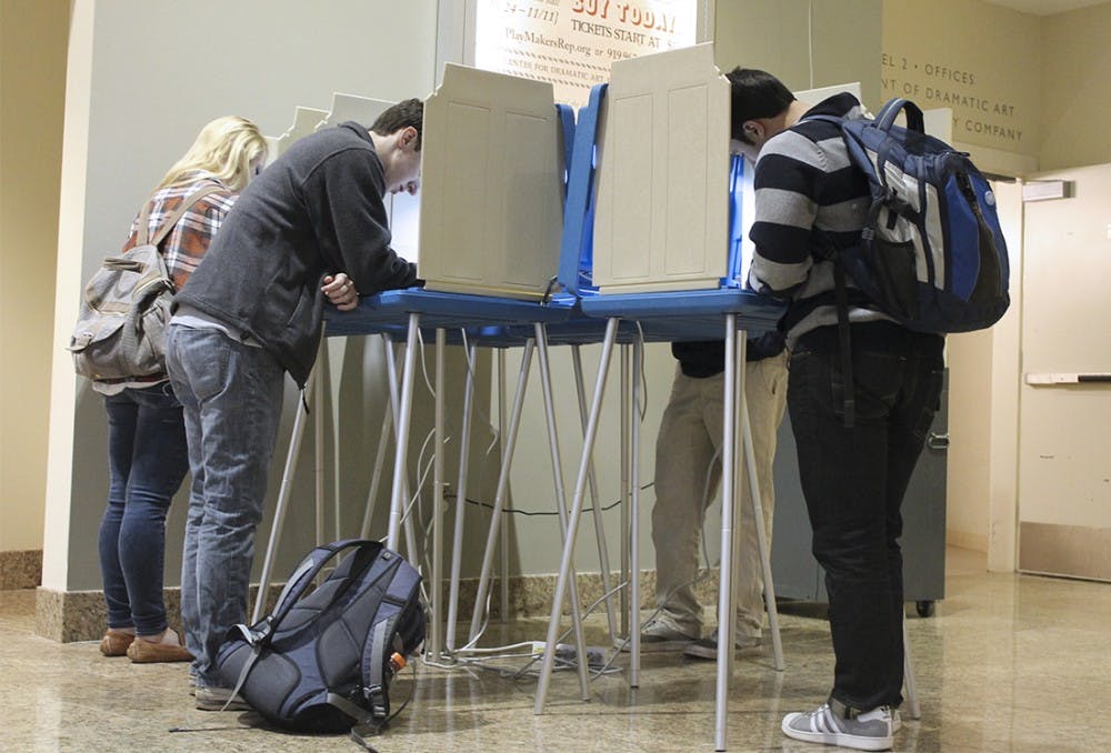 Students vote during the 2012 election at the Center for Dramatic Arts. Students must register today to vote in the primaries.