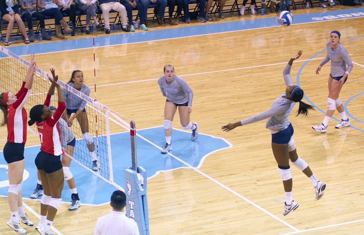 Taylor Leath (43) spikes the ball over the net against Louisville Friday night. 