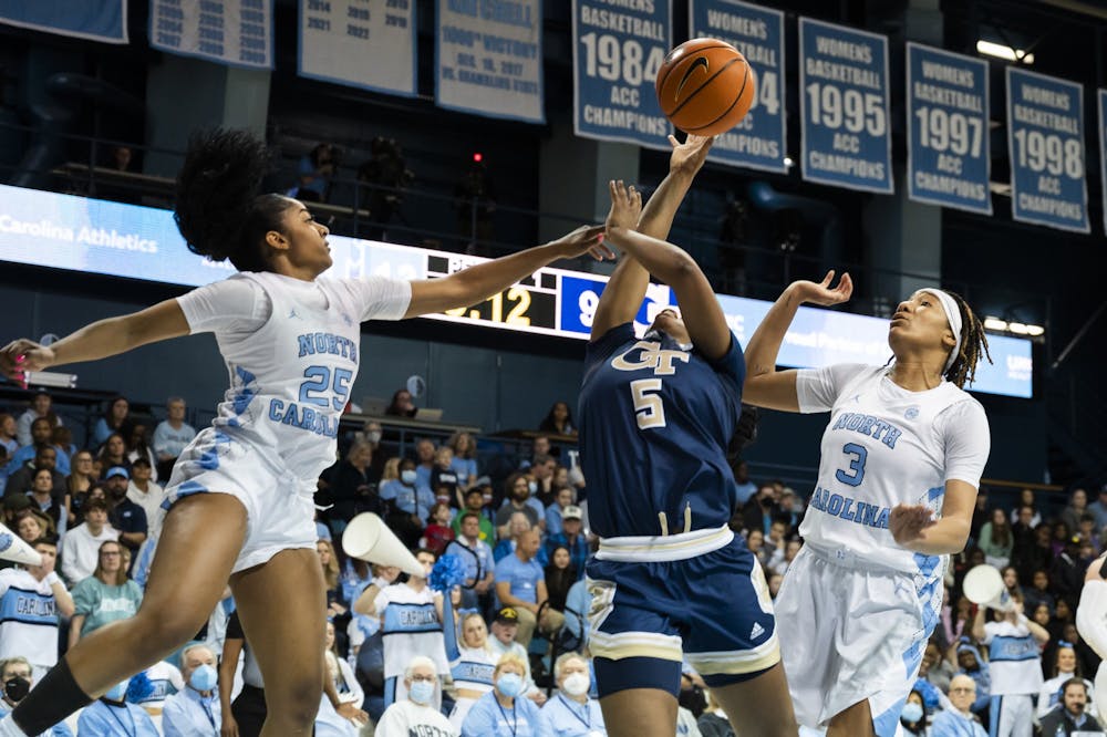 <p>UNC junior guard Deja Kelly (25) and junior guard Kennedy Todd-Williams (3) defend the basket during a basketball game against Georgia Tech on Sunday, Jan. 22, 2023, in Carmichael Arena. UNC won 70-57.</p>