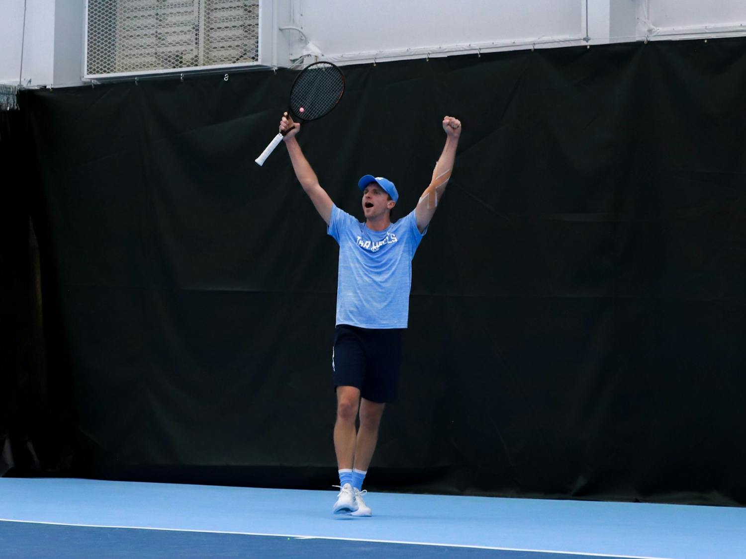 UNC graduate student Brian Cernoch celebrates a point against Harvard on Sunday, January 29, 2023, at the Cone-Kenfield Tennis Center. UNC beat Harvard 4-1, winning them a ticket to Chicago.