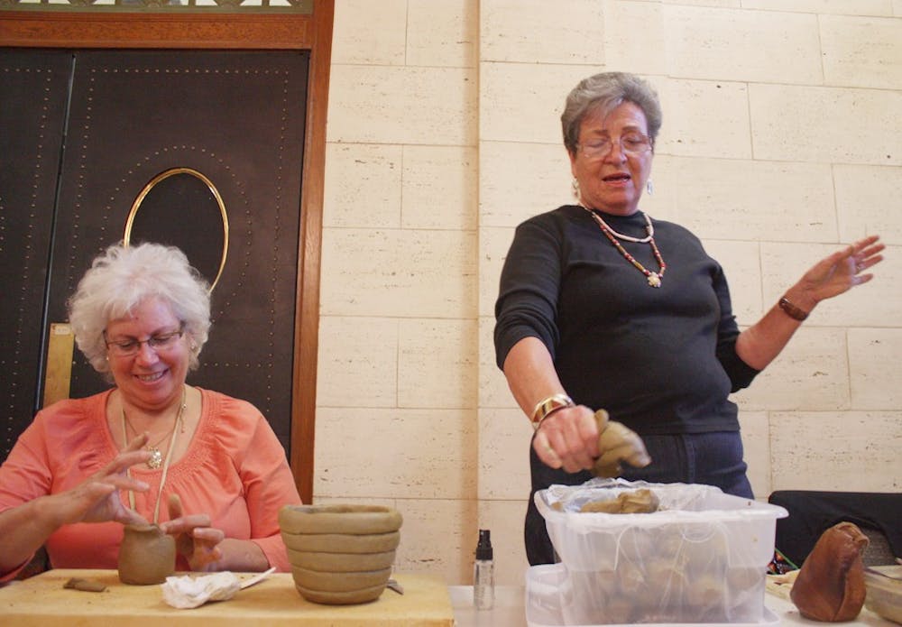 Beckee Garris and Caroleen Sanders conduct a pottery-making demonstration in Wilson Library. The program was part of an event to showcase “Unearthing Native History: The UNC Catawba Archaeological Project.” 