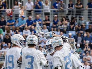 Members of the men's lacrosse team celebrate after a goal against Duke Saturday, March 30, 2019 at the UNC Lacrosse Stadium. The Tar Heels beat Duke 10-8.