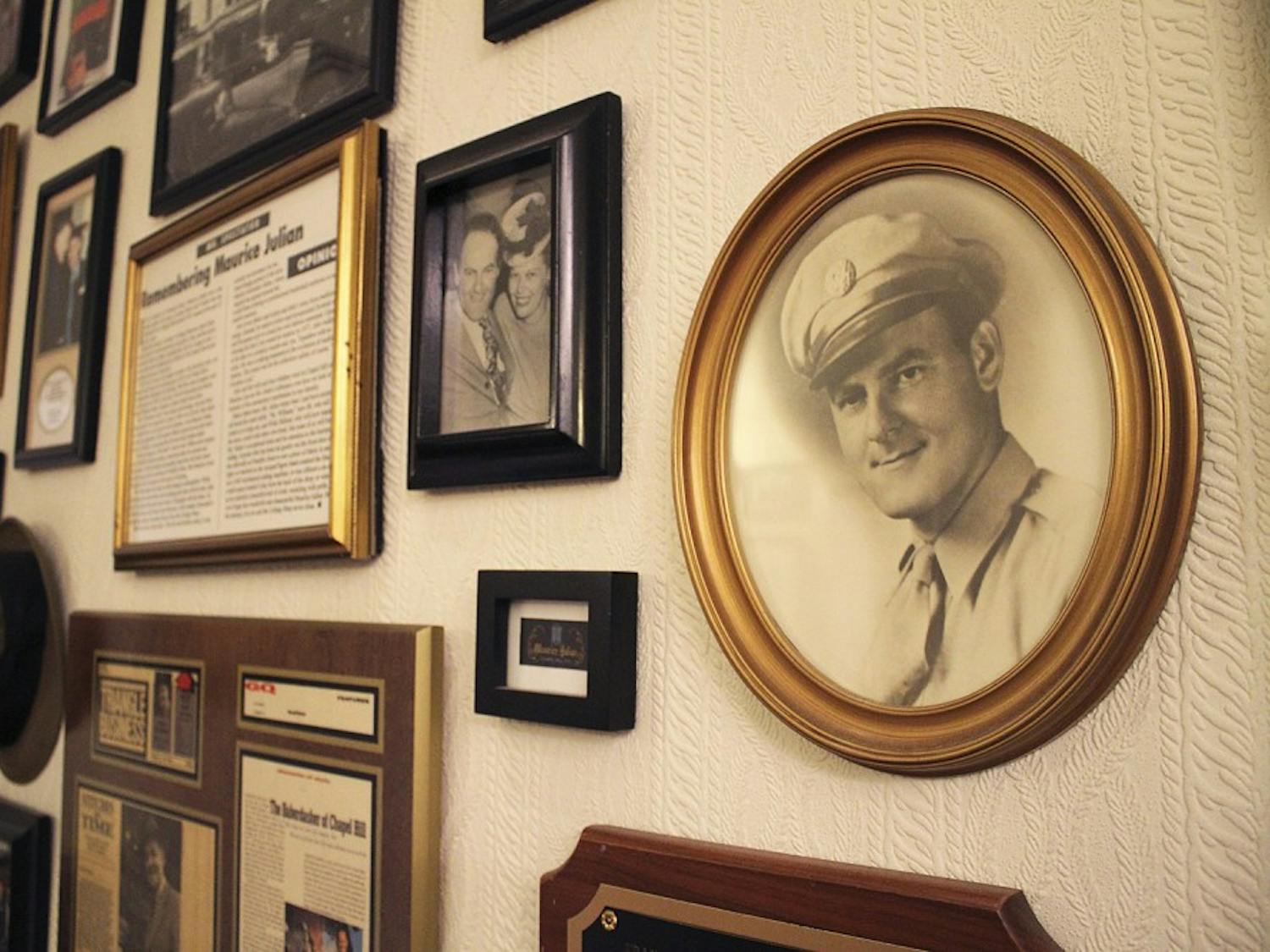 Photos and articles commemorating business leader Maurice Julian (right) and his family hang on the back wall in Julian’s on Franklin Steet.