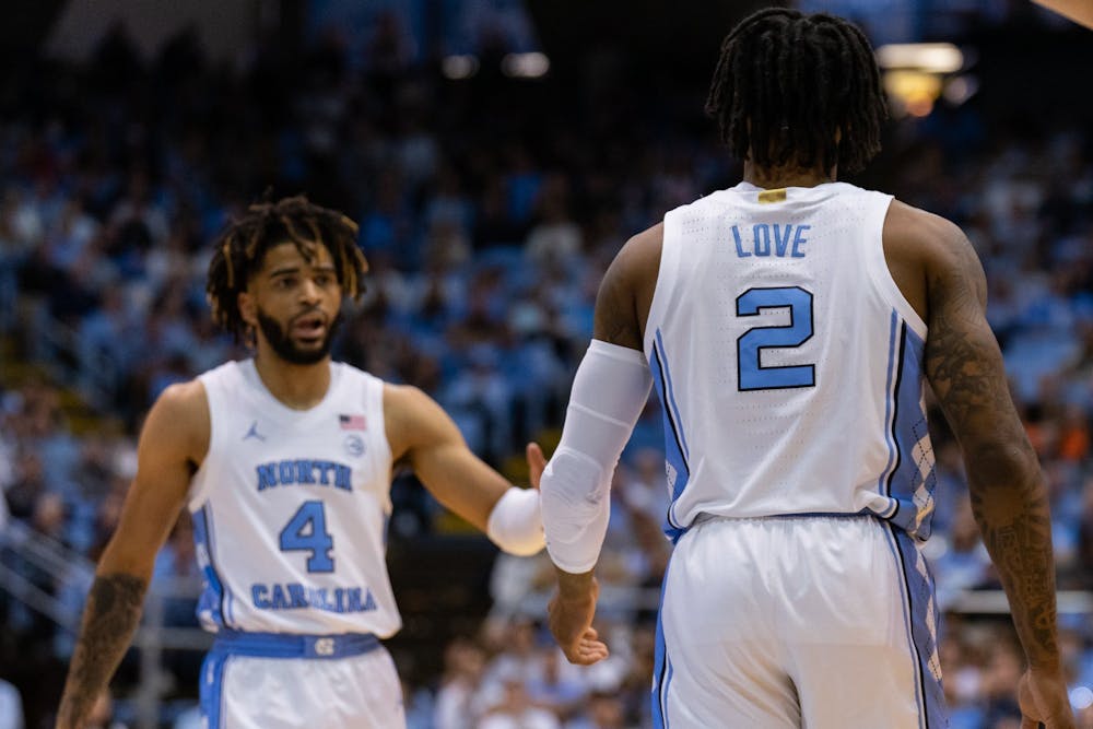 UNC junior guard RJ Davis (4) and junior guard Caleb Love (2) high five after a made basket during the men’s basketball game against Clemson on Saturday, Feb. 11, 2023, at the Dean E. Smith Center. UNC beat Clemson 91-71.