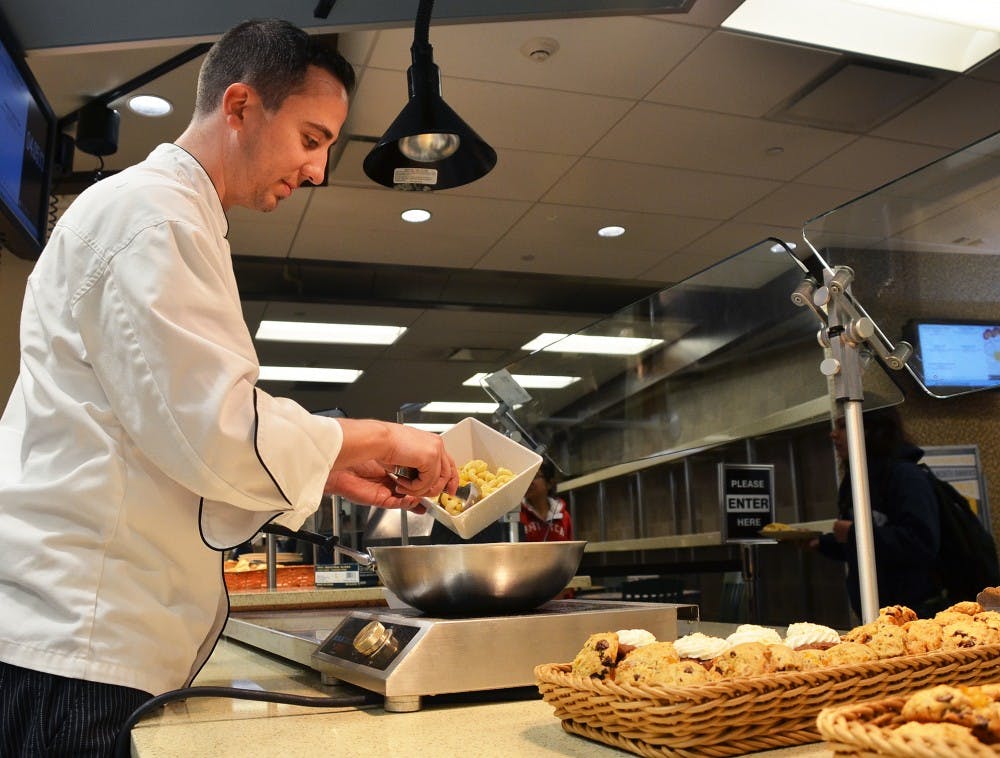 UNC executive chef Paul Calice? prepares food at Lenoir before the dinner rush. 
