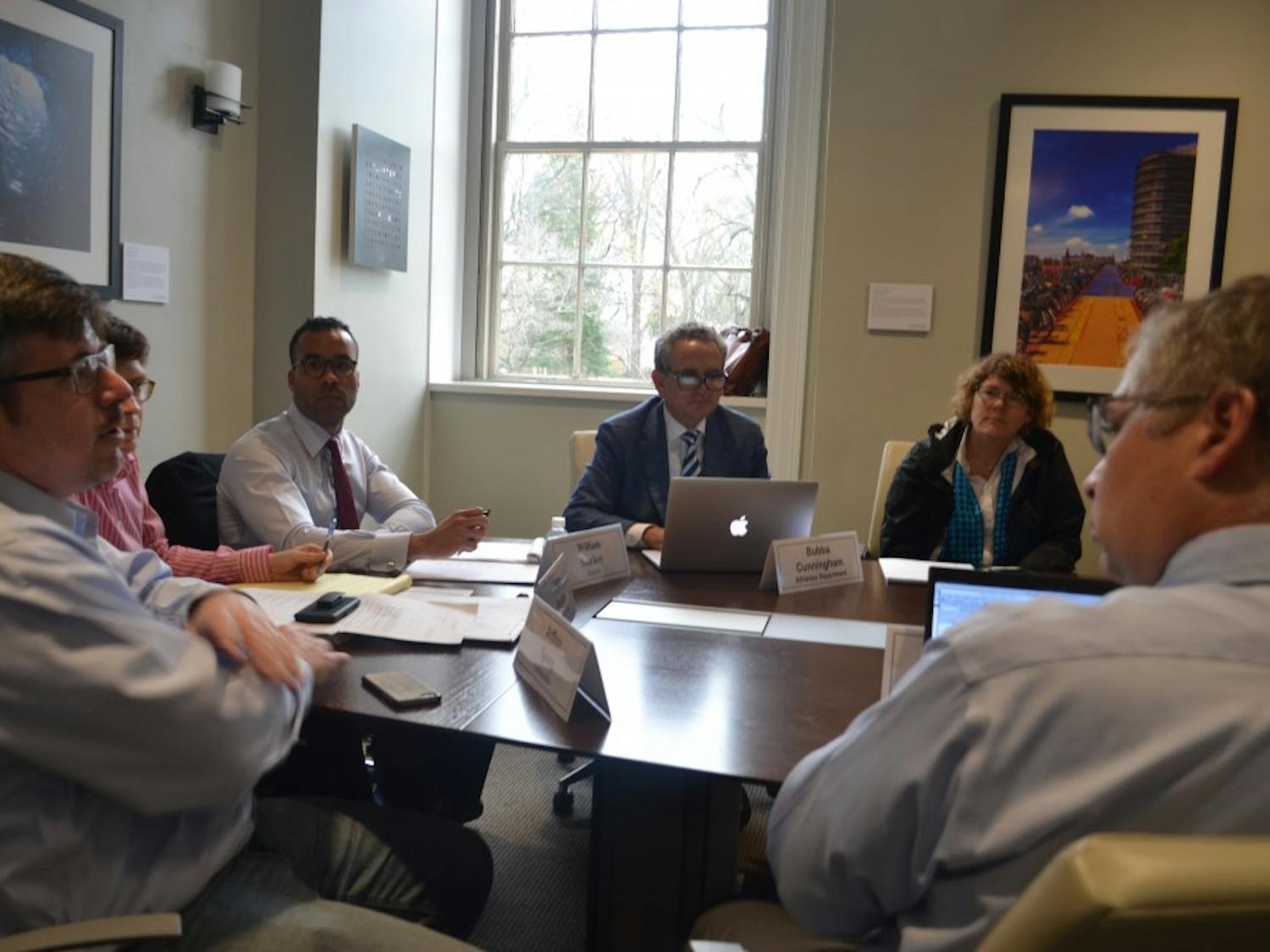 Jaye Cable, Bubba Cunningham, William Sturkey, Lissa Broome, and Jeffrey Spang discuss the minutes during the Faculty Executive Committee on Tuesday afternoon. 