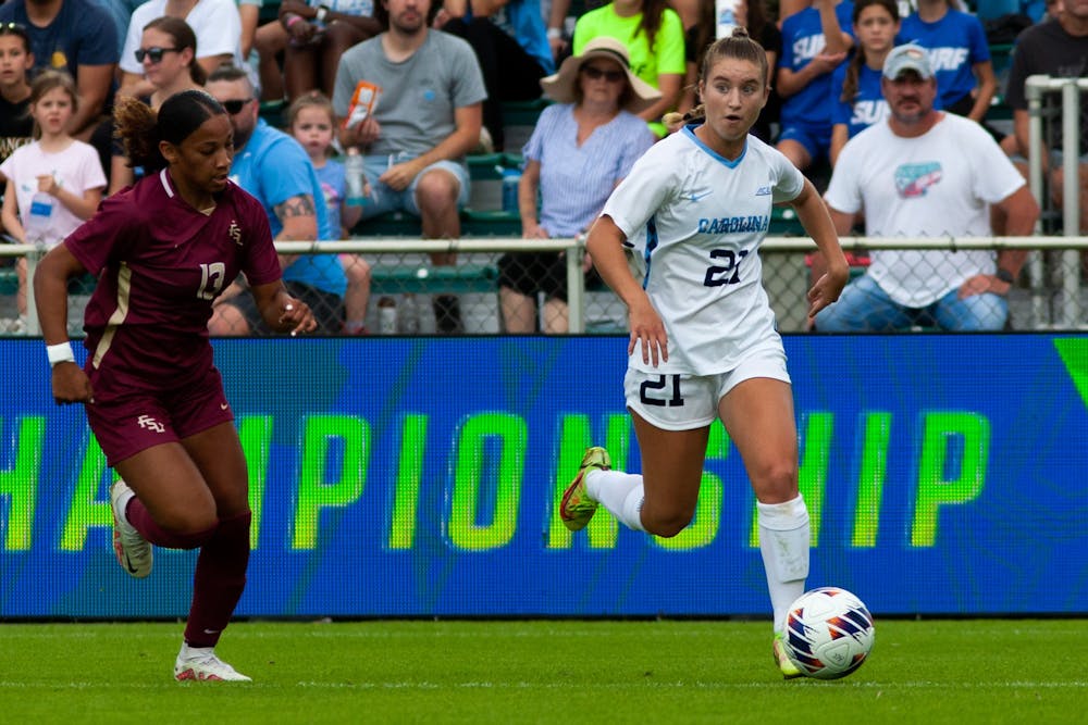 <p>UNC redshirt first-year forward Ally Sentnor (21) protects the ball during the women's soccer 1-2 loss in the ACC Finals against FSU at WakeMed Soccer Park on Sunday, Nov. 6, 2022.</p>