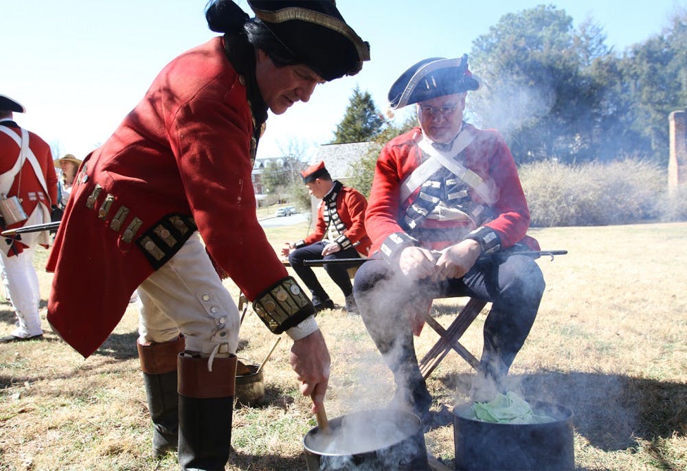 Revolutionary War reenactment as part of Twelfth Annual Revolutionary War Living History Day in Hillsborough Saturday 2-22-14. 

Reenactment of His Majesty's 64th regiment of foot during the year of 1781. 

Right-  Mark Dappert is from Charlotte, reenacting a Sgt., been reenacting for 25 years. Here he is cooking "spotted dog," salt pork and cabbage.

Left- David Snyder is from Efland, reenacting a Captain of Infantry, been reenacting since 1976 and started because of the bicentennial. He has an interest in American history and wanted to learn more about the British side of the story. 