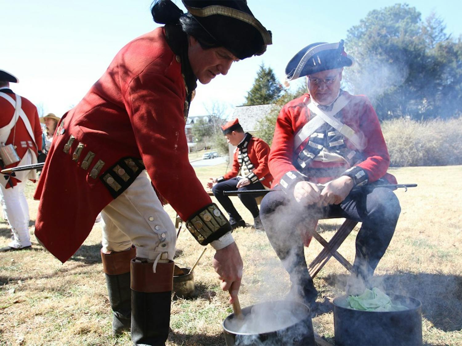 Revolutionary War reenactment as part of Twelfth Annual Revolutionary War Living History Day in Hillsborough Saturday 2-22-14. Reenactment of His Majesty's 64th regiment of foot during the year of 1781. Right-  Mark Dappert is from Charlotte, reenacting a Sgt., been reenacting for 25 years. Here he is cooking "spotted dog," salt pork and cabbage.Left- David Snyder is from Efland, reenacting a Captain of Infantry, been reenacting since 1976 and started because of the bicentennial. He has an interest in American history and wanted to learn more about the British side of the story. 