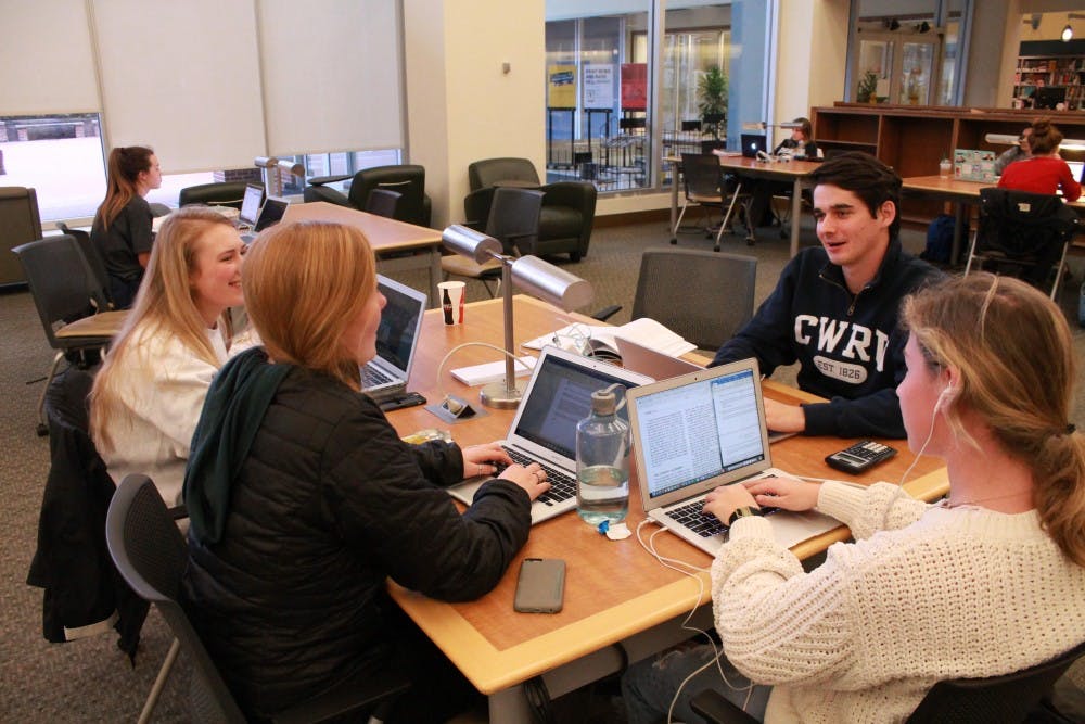 From left to right: Lauren Atkinson, Grace Clarke, Lauren Chamblee, and Sam White talk about homework together in Davis Library.