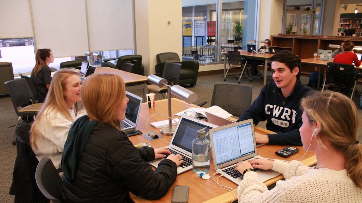 From left to right: Lauren Atkinson, Grace Clarke, Lauren Chamblee, and Sam White talk about homework together in Davis Library.