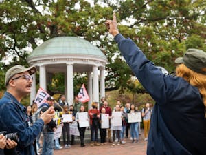 UNC housekeeper chants to the crowd during the UNC Housekeepers March & Rally at the Old Well on Oct. 28, 2022.