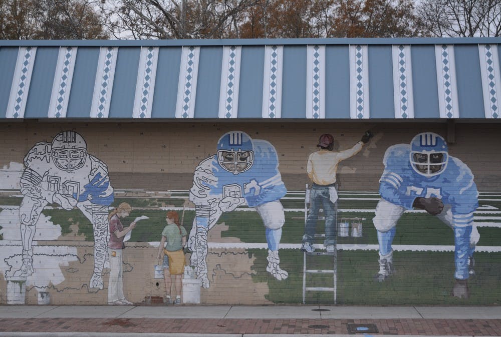 The paint-by-number mural features UNC football players and is located on the side of Pantana Bob's. 
