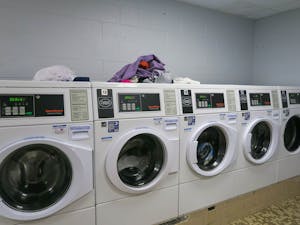 Dirty laundry is placed above the laundry machines in Granville Towers on April 11, 2023. It is requested for residents to not leave laundry unattended.