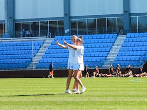 UNC junior attacker Reilly Casey (7) and junior midfielder Alyssa Long (10) celebrate after the game against UF on Saturday, Feb. 18, 2023, at Dorrance Field. UNC beat UF 12-5.
