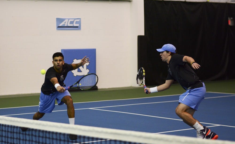 Anu Kodali (left) returns a backhand volley at the net with doubles partner Ronnie Schneider (right) in Saturday's match against Ole Miss. 