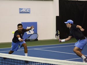Anu Kodali (left) returns a backhand volley at the net with doubles partner Ronnie Schneider (right) in Saturday's match against Ole Miss. 