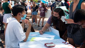 UNC-Chapel Hill students take part in UNC's 2021 SmallFest, an adapted version of the FallFest tradition from years past, on Aug. 24, 2021. Despite the COVID modifications--fewer organizations at one time, a shorter time frame each day, and lengthening SmallFest to a week-long endeavor--students turn out in droves for free swag, fun activities, and, of course, to find organizations to join.