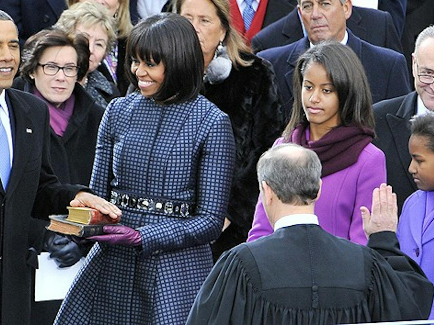President Barack Obama is sworn-in for a second term as the President of the United States by Supreme Court Chief Justice John Roberts during his public inauguration ceremony at the U.S. Capitol Building in Washington, D.C. on January 21, 2013. The first family looks on. (Mark Gail/MCT)