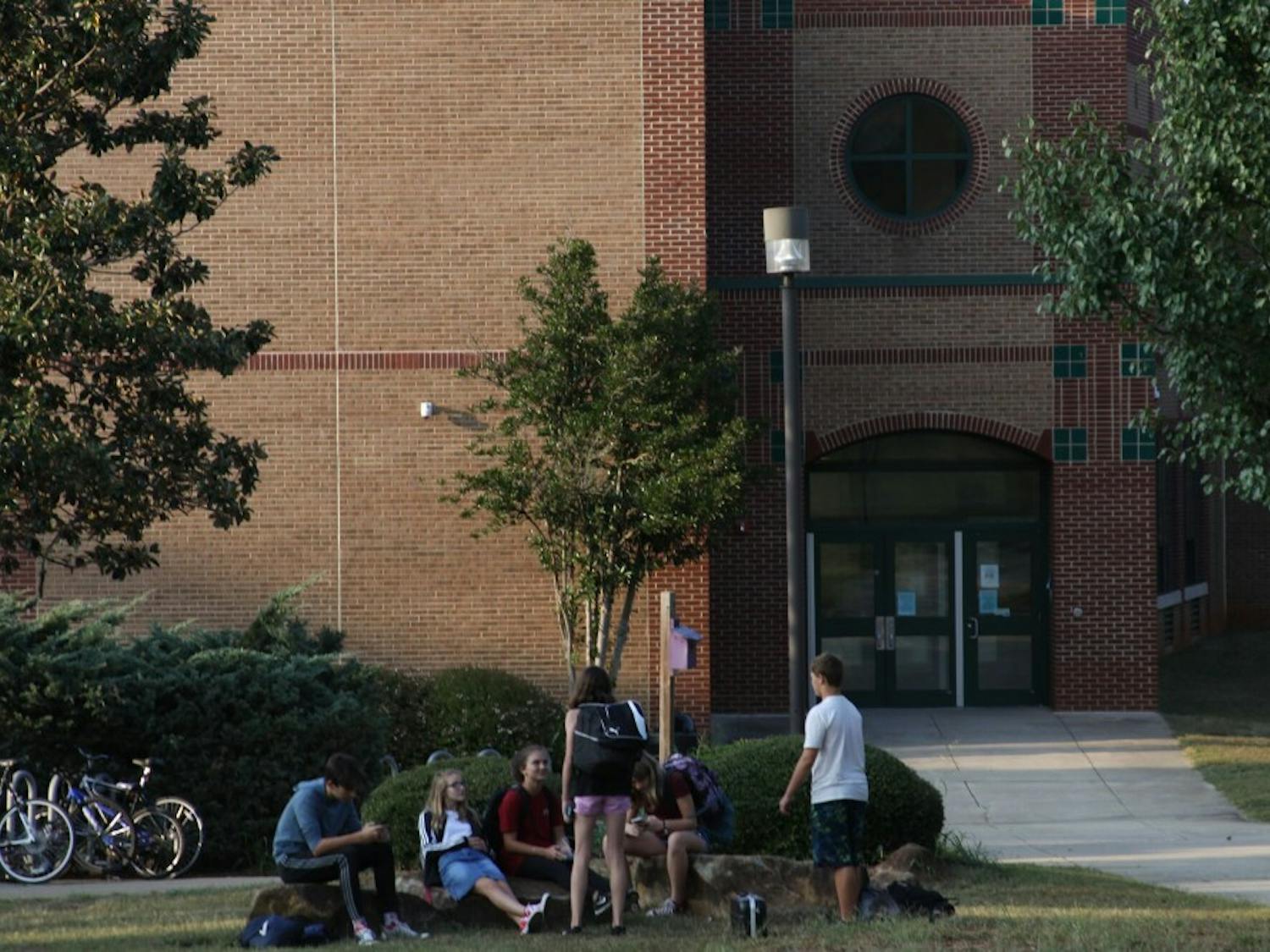 Students at East Chapel Hill High School spend time outside after school is let out.&nbsp;