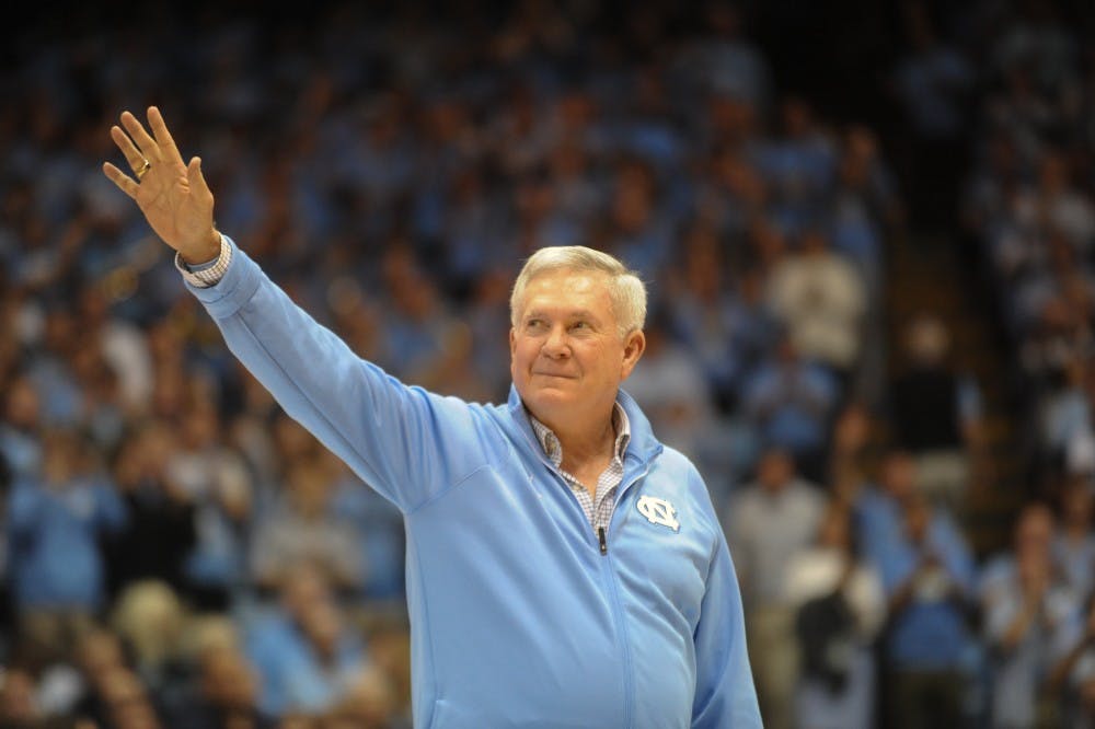 UNC head football coach Mack Brown waves to the crowd as he and his coaching staff were introduced at the Dean Smith Center during Saturday's basketball game against Gonzaga. 