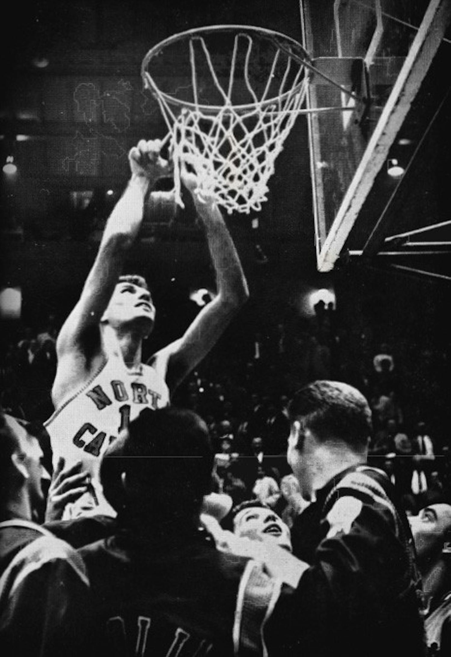 Lennie Rosenbluth helps cut down the nets. Courtesy of the North Carolina Collection.