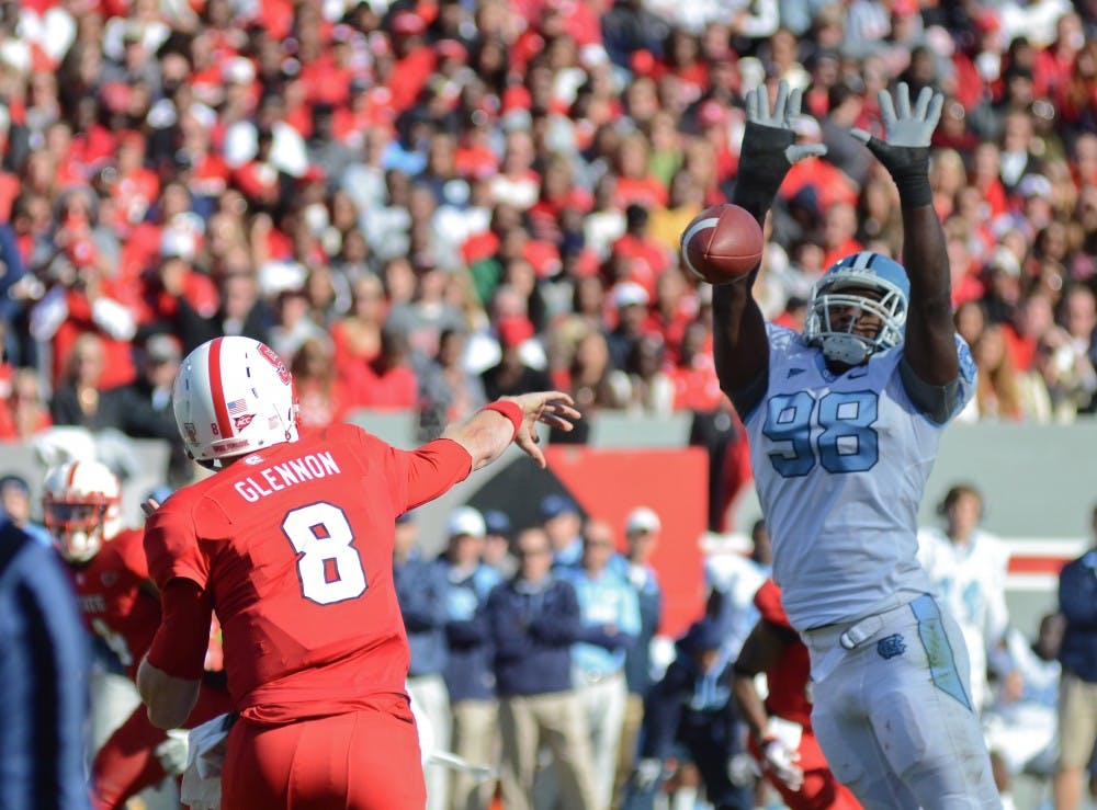 	<p><span class="caps">UNC</span> defensive end Donte Paige-Moss attempts to block NC State quaterback Mike Glennon&#8217;s pass in <span class="caps">UNC</span>&#8217;s 13-0 loss to NC State at Carter-Finley Stadium in Raleigh, NC. </p>