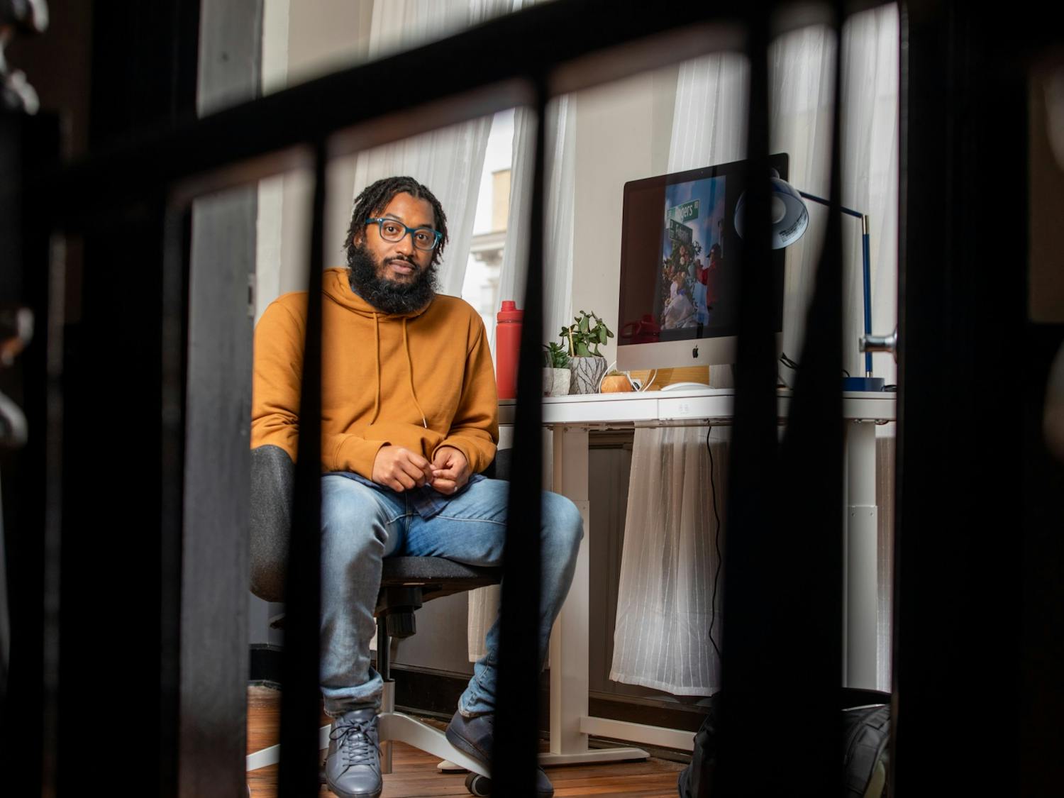 Photographer Cornell Watson, the creator of "Tarred Healing," poses for a portrait in his Durham office on Saturday, Feb. 26, 2022. "Tarred Healing" is a photo story reflecting on Black history in Chapel Hill and at UNC.