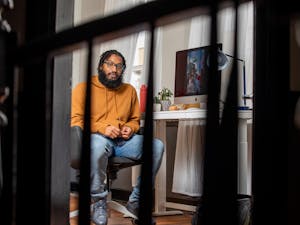 Photographer Cornell Watson, the creator of "Tarred Healing," poses for a portrait in his Durham office on Saturday, Feb. 26, 2022. "Tarred Healing" is a photo story reflecting on Black history in Chapel Hill and at UNC.
